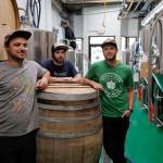 Jake Ridle, left, Ryan Lindsay, center, and Evan Wood in their Devils Club Brewing Company brewery on Tuesday, Aug. 27, 2019. (Michael Penn | Juneau Empire)