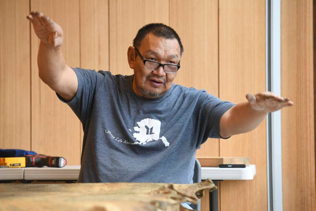 John Waghiyi Jr., artist and whaling captain, talks about preparing a walrus hide as he sews a blanket at the Walter Soboleff Center on Tuesday, Aug. 27, 2019. the Waghiyis will demonstrate dances from their region from noon-1 pm, Wednesday, Aug. 28, for the public at SHI. (Michael Penn | Juneau Empire)