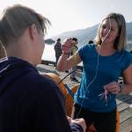 Dzantiki Heeni Middle School math teacher Tennie Bentz helps students pick lures while fishing for salmon at the Wayside Park on Channel Drive on Friday, Aug. 30, 2019. The fish will be used in a dog treat business the students are developing to raise money for a water filtering system to be used at the school. Two math teachers Bobby Jones and Tennie Bentz, are having the students start four businesses as a way of teaching the use of math in the real world. (Michael Penn | Juneau Empire)