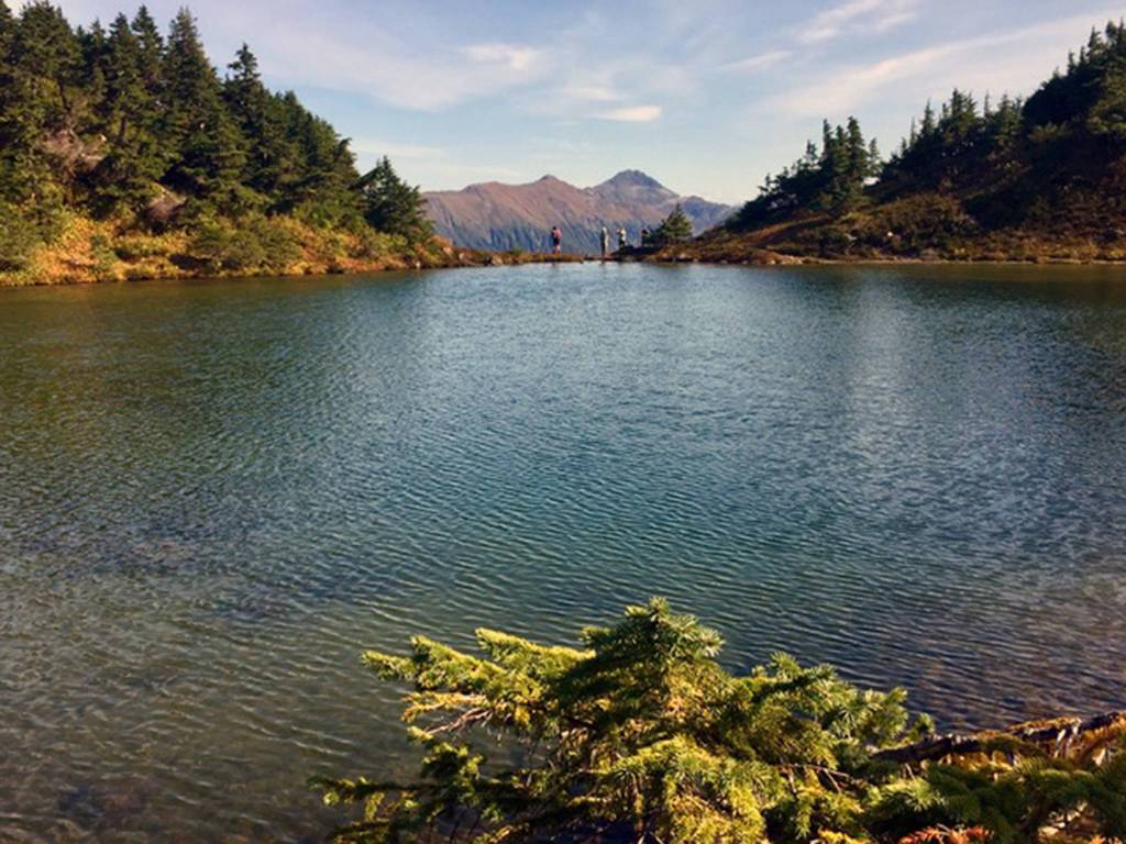 Hikers stand at the edge of Naked Man Lake, below East end of Mount Troy, on Sept. 6, 2019. (Courtesy photo | Sandy R. Williams)
