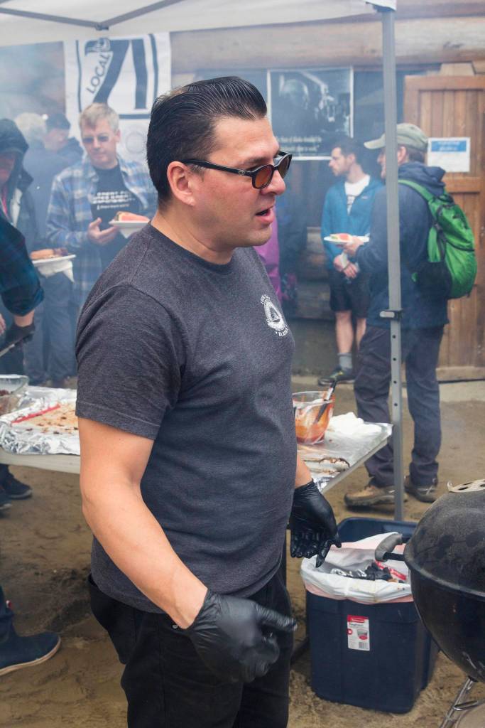 Rodney Hesson, with the International Brotherhood of Electrical Workers, makes ribs during the Juneau Central Labor Councils annual Labor Day picnic at Savikko Park, Monday, Sept. 2, 2019. (Michael S. Lockett | Juneau Empire)