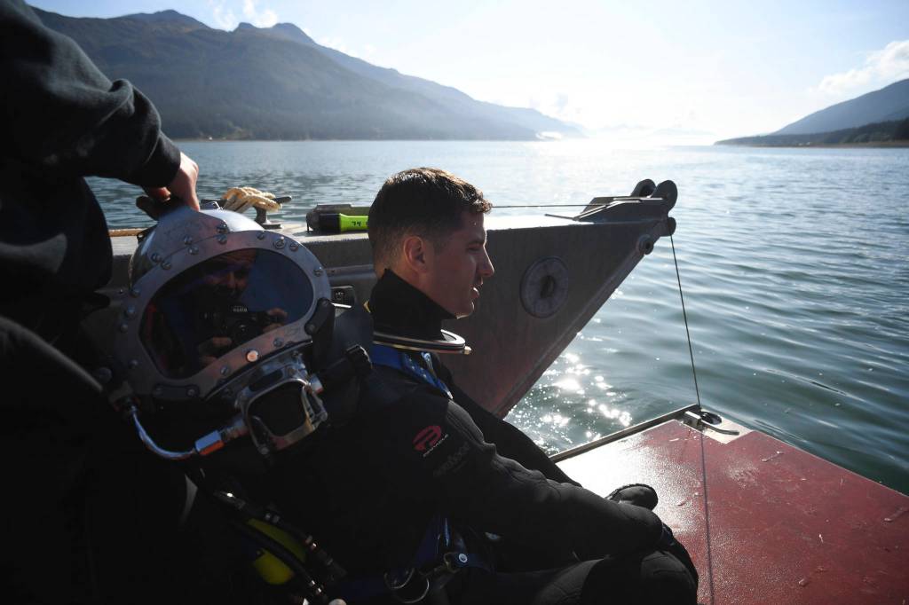 Members of the Armys 74th Engineer Dive Detachment work off a Juneau Harbormaster boat to retrieve lost crab pots in Gastineau Channel for the Douglas Indian Association/NOAA Marine Debris Project on Thursday, Sept. 5, 2019. The project aims to identify and remove derelict crab pots and their continued negative impact on wildlife and the environment. (Michael Penn | Juneau Empire)