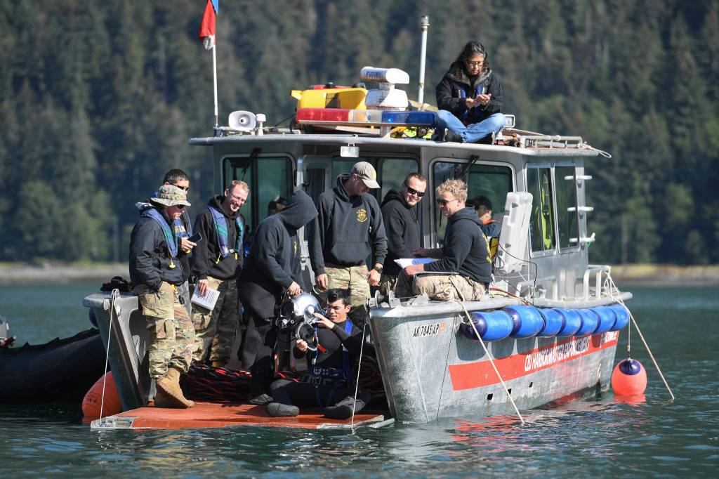 Members of the Armys 74th Engineer Dive Detachment work off a Juneau Harbormaster boat to retrieve lost crab pots in Gastineau Channel for the Douglas Indian Association/NOAA Marine Debris Project on Thursday, Sept. 5, 2019. The project aims to identify and remove derelict crab pots and their continued negative impact on wildlife and the environment. (Michael Penn | Juneau Empire)