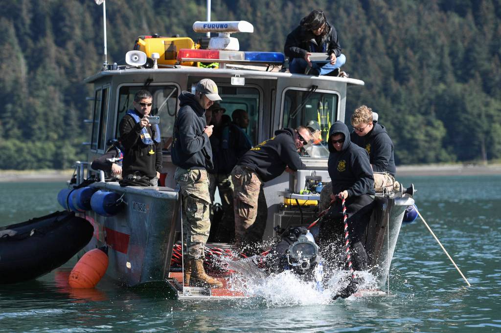 Members of the Armys 74th Engineer Dive Detachment work off a Juneau Harbormaster boat to retrieve lost crab pots in Gastineau Channel for the Douglas Indian Association/NOAA Marine Debris Project on Thursday, Sept. 5, 2019. The project aims to identify and remove derelict crab pots and their continued negative impact on wildlife and the environment. (Michael Penn | Juneau Empire)