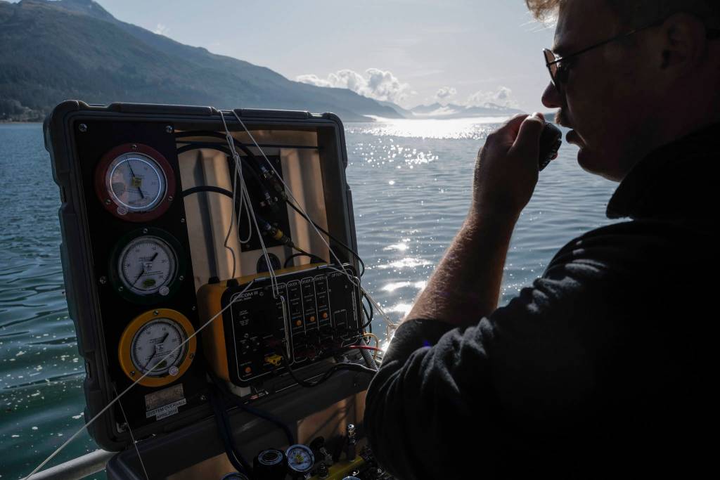 Members of the Armys 74th Engineer Dive Detachment work off a Juneau Harbormaster boat to retrieve lost crab pots in Gastineau Channel for the Douglas Indian Association/NOAA Marine Debris Project on Thursday, Sept. 5, 2019. The project aims to identify and remove derelict crab pots and their continued negative impact on wildlife and the environment. (Michael Penn | Juneau Empire)