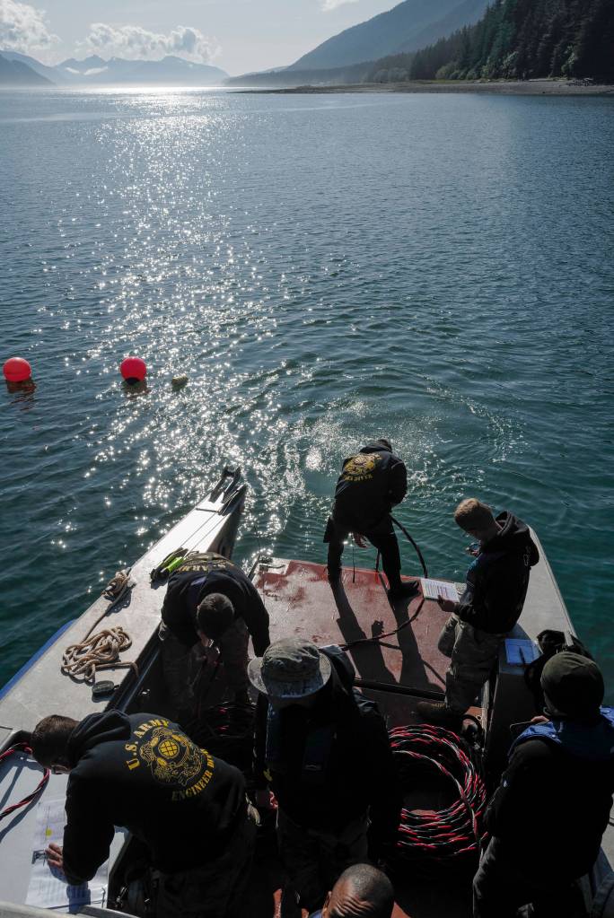 Members of the Armys 74th Engineer Dive Detachment work off a Juneau Harbormaster boat to retrieve lost crab pots in Gastineau Channel for the Douglas Indian Association/NOAA Marine Debris Project on Thursday, Sept. 5, 2019. The project aims to identify and remove derelict crab pots and their continued negative impact on wildlife and the environment. (Michael Penn | Juneau Empire)