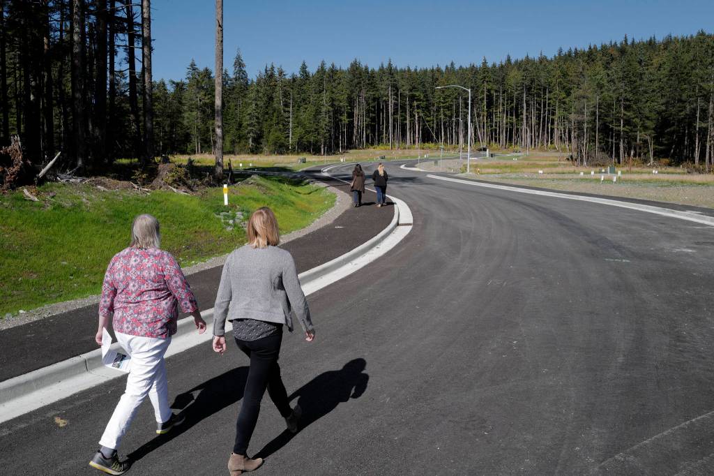 Mayor Beth Weldon and Assembly Member Carole Triem take a stroll on Karl Reishus Boulevard after a ribbon-cutting ceremony to commemorate the near completion of the Pederson Hill Subdivision on Friday, Sept. 6, 2019. Reishus was a Juneau Police Department officer who died in 1992 when he fell from a 40-foot tower during a training exercise. (Michael Penn | Juneau Empire)