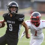 Juneaus Wallace Adams avoids a tackle by Wasillas Kahuna Patterson in the first quarter at Adair-Kennedy Memorial Field on Friday, Sept. 6, 2019. Juneau won 63-0. (Michael Penn | Juneau Empire)