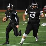 Juneaus Gaby Soto, left, follows the blocking of teammate Marcos Yadao against Wasilla at Adair-Kennedy Memorial Field on Friday, Sept. 6, 2019. Juneau won 63-0. (Michael Penn | Juneau Empire)