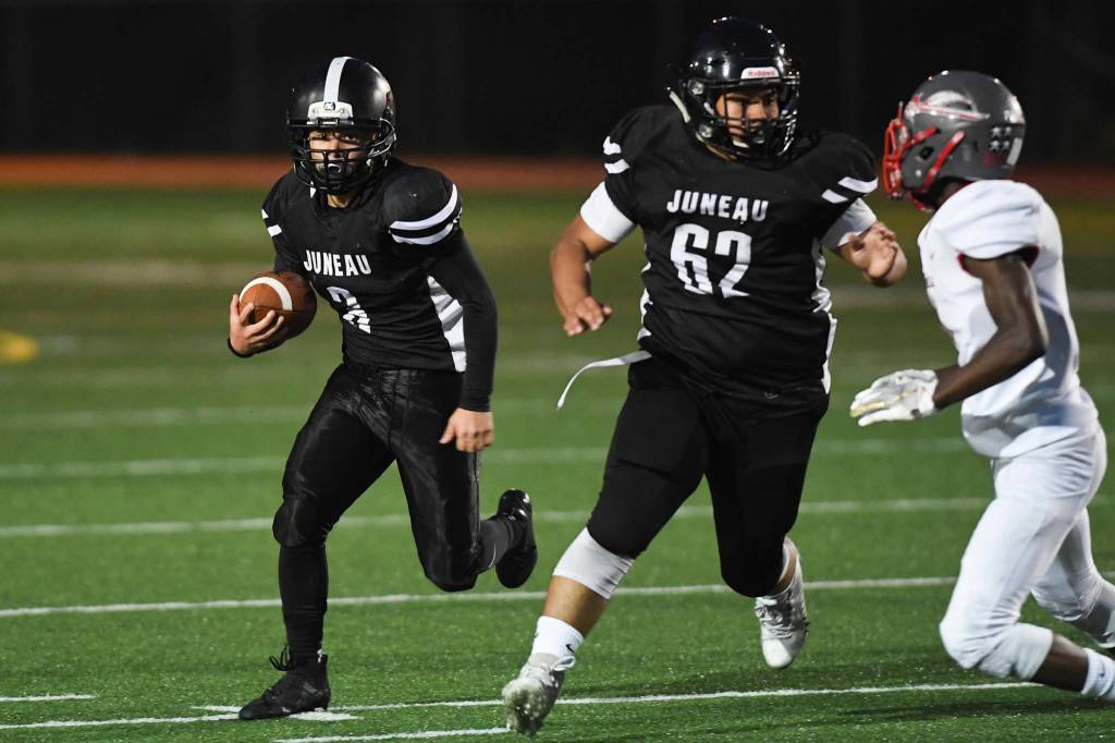 Juneaus Gaby Soto, left, follows the blocking of teammate Marcos Yadao against Wasilla at Adair-Kennedy Memorial Field on Friday, Sept. 6, 2019. Juneau won 63-0. (Michael Penn | Juneau Empire)