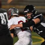 Juneaus Jake Ferster stops Wasillas quarterback Colton Lindquist in the second quarter at Adair-Kennedy Memorial Field on Friday, Sept. 6, 2019. Juneau won 63-0. (Michael Penn | Juneau Empire)