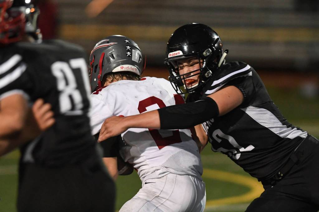 Juneaus Jake Ferster stops Wasillas quarterback Colton Lindquist in the second quarter at Adair-Kennedy Memorial Field on Friday, Sept. 6, 2019. Juneau won 63-0. (Michael Penn | Juneau Empire)