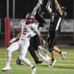 Juneaus Wallace Adams, right, intercepts a pass intended for Wasillas Luke Devine, left, in the third quarter at Adair-Kennedy Memorial Field on Friday, Sept. 6, 2019. Juneaus Jahrease Mays, center, was also in on the play. Juneau won 63-0. (Michael Penn | Juneau Empire)