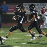 Juneaus Wallace Adams, center, runs after intercepting a pass against Wasilla in the third quarter at Adair-Kennedy Memorial Field on Friday, Sept. 6, 2019. Juneau won 63-0. (Michael Penn | Juneau Empire)
