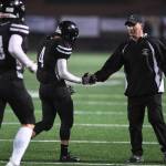Juneaus head coach Rich Sjoroos congratulates Ali Beya, center, and Cooper Kriegmont in the third quarter as they compete against Wasilla at Adair-Kennedy Memorial Field on Friday, Sept. 6, 2019. Juneau won 63-0. (Michael Penn | Juneau Empire)