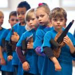 In this November 2013 photo, kindergartners give looks of anticipation before their first Kindergarten Paper Violin Concert at Glacier Valley Elementery School Wednesday. This is JAMMs 10th anniversary and they will have a cruise Saturday. (Michael Penn | Juneau Empire File)