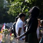 A woman stands next to the north pool prior to a ceremony marking the 18th anniversary of the attacks of Sept. 11, 2001 at the National September 11 Memorial, Wednesday, Sept. 11, 2019 in New York. (AP Photo/Mark Lennihan)