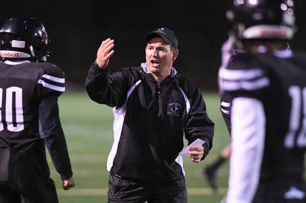 Juneaus coach Rich Sjoroos speaks to his players as they play against West at Adair-Kennedy Memorial Field on Friday, Sept. 13, 2019. West won 43-14. (Michael Penn | Juneau Empire)