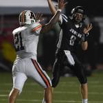 Juneaus Noah Chambers is pressured by Wests Christian Turituri in the second quarter at Adair-Kennedy Memorial Field on Friday, Sept. 13, 2019. West won 43-14. (Michael Penn | Juneau Empire)