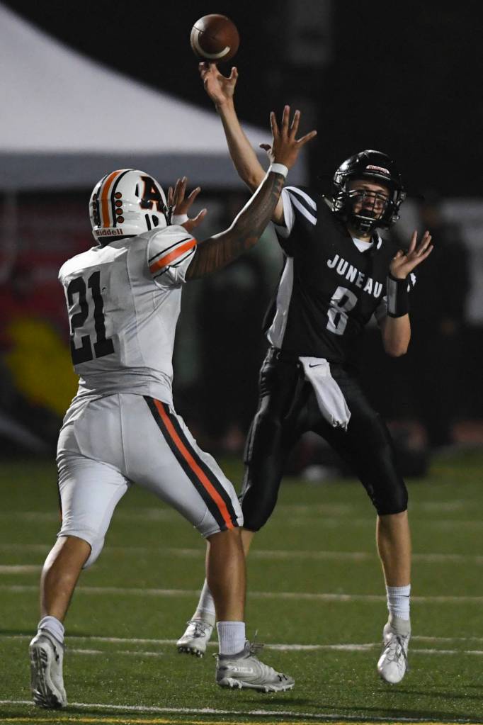 Juneaus Noah Chambers is pressured by Wests Christian Turituri in the second quarter at Adair-Kennedy Memorial Field on Friday, Sept. 13, 2019. West won 43-14. (Michael Penn | Juneau Empire)
