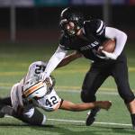 Juneaus Ali Beya, right, runs against Wests Romeo Vaimili in the third quarter at Adair-Kennedy Memorial Field on Friday, Sept. 13, 2019. West won 43-14. (Michael Penn | Juneau Empire)