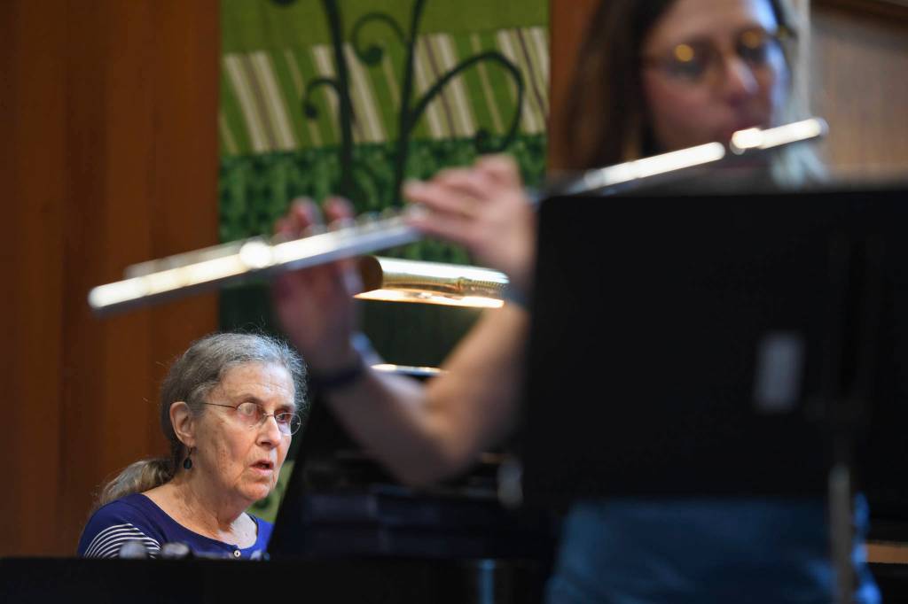 Nancy Nash, on piano, left, and Sally Schlichting, on flute, rehearse for the Con Brio Chamber Series concert of music by women composers at Northern Light United Church on Sept. 17, 2019. (Michael Penn | Juneau Empire)