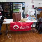 Ralphenia Knudson, left, and Carolyn Garcia, of the American Red Cross, set up a table at the Mount Roberts Tramway as rescuers gather to find a lost hiker on Mount Roberts on Friday, Sept. 20, 2019. (Michael Penn | Juneau Empire)