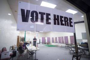 Election officials wait for voters in the Municipal Election at the Nugget Mall on Tuesday, Oct. 2, 2018. Estimates indicate Alaska has registered 109 percent of its eligible voters. This years election will be Oct. 1, and groups are spending in support or opposition of ballot measures. (Michael Penn | Juneau Empire File)