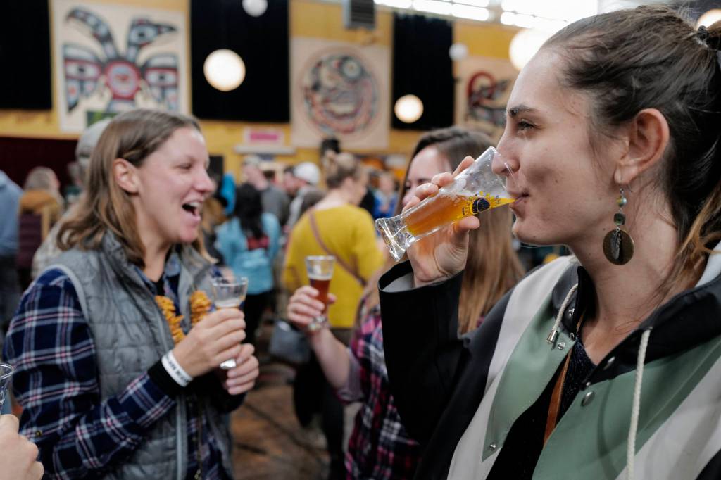 Malia Stauffer, right, drinks with friends at the Rotary Club of Juneaus Eighth Annual Capital Brewfest at the Juneau Arts and Culture Center on Saturday, Sept. 21, 2019. Twenty brewing and distribution companies were on hand for the fundraiser to benefit the University of Alaska and Rotarys service projects, scholarships, international youth exchanges and other project. The event was sold out with 900 tickets sold. (Michael Penn | Juneau Empire)