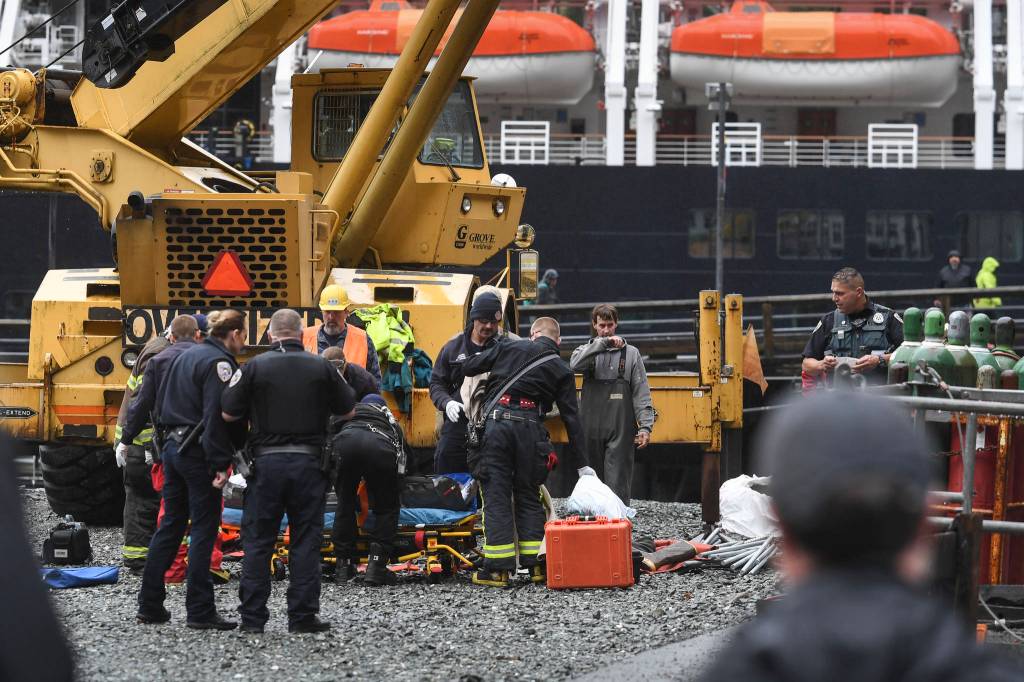 Juneau Police Department officers and Capital City Fire/Rescue personnel respond to an accident at the Downtown Public Library on Monday, Sept. 23, 2019. A construction worker was injured at a work site after a driver reportedly drove through the library parking barrier. (Michael Penn | Juneau Empire)
