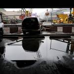 Juneau Police Department officers and Capital City Fire/Rescue personnel respond to an accident at the Downtown Public Library on Monday, Sept. 23, 2019. A construction worker was injured at a work site after a driver reportedly drove through the library parking barrier. (Michael Penn | Juneau Empire)