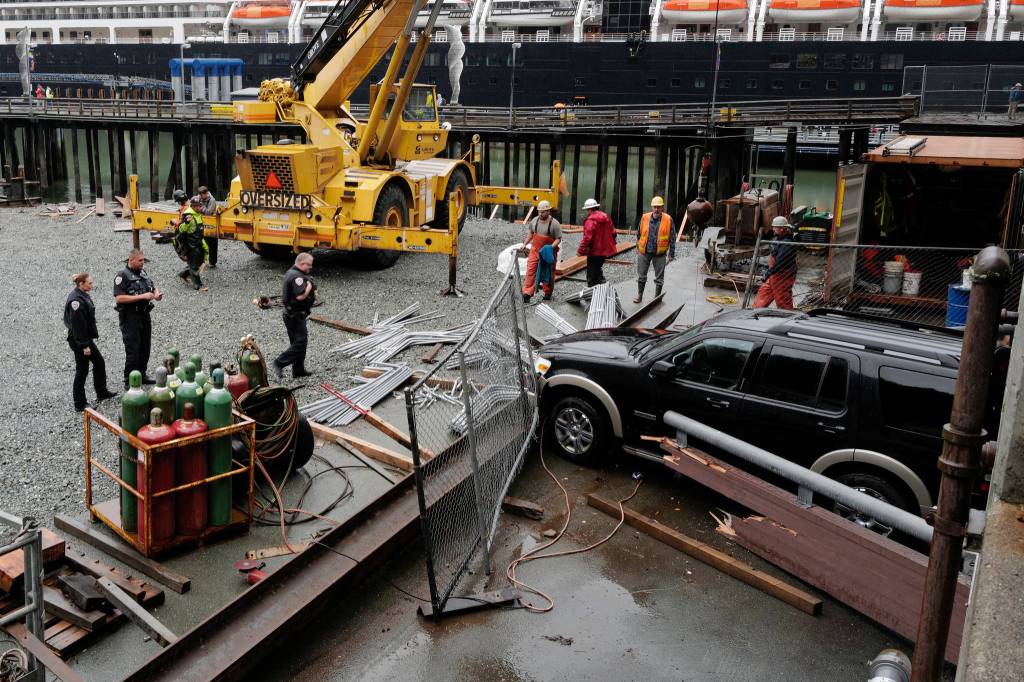 Juneau Police Department officers and Capital City Fire/Rescue personnel respond to an accident at the Downtown Public Library on Monday, Sept. 23, 2019. A construction worker was injured at a work site after a driver reportedly drove through the library parking barrier. (Michael Penn | Juneau Empire)