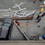 Juneau Police Department officers and Capital City Fire/Rescue personnel respond to an accident at the Downtown Public Library on Monday, Sept. 23, 2019. A construction worker was injured at a work site after a driver reportedly drove through the library parking barrier. (Michael Penn | Juneau Empire)