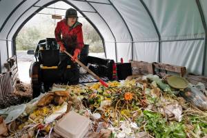 Lisa Daugherty, owner of Juneau Composts!, spreads out newly-collected food waste and compostable material at her half-acre site in Lemon Creek on Tuesday, Sept. 24, 2019. Daugherty is offering to take home owners leaves this fall. Daugherty has put up signs where to deposit leaves, but not plastic bags, at her business on Ralphs Way. (Michael Penn | Juneau Empire)