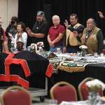 Eric Hollinger, Tribal Liaison for the Repatriation Office of the Smithsonians National Museum of Natural History, left, pushes in a cart holding the original sculpin clan hat for a welcoming ceremony at Elizabeth Peratrovich Hall on Wednesday, Sept. 25, 2019. The hat was collected from the Kiks.ádi Clan in Sitka in 1884. The Smithsonian Institution used a 3D digitization process to document the hat and constructed a replica hat using traditional materials. (Michael Penn | Juneau Empire)