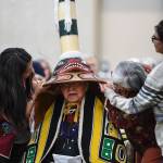 Members of the Killer Whale Clan support a replica of a sculpin clan hat on Ray Wilson, clan leader for the Kiks.ádi Clan, during a welcoming ceremony at Elizabeth Peratrovich Hall on Wednesday, Sept. 25, 2019. The original hat was collected from the Kiks.ádi Clan in Sitka in 1884. The Smithsonian Institution used a 3D digitization process to document the hat and constructed the hat using traditional materials. (Michael Penn | Juneau Empire)