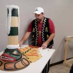 Eric Hollinger, Tribal Liaison for the Repatriation Office of the Smithsonians National Museum of Natural History, left, and Chris Hollshwander, exhibition specialist and modelmaker for the Smithsonian, prepare a replica of a sculpin clan hat before a welcoming ceremony at Elizabeth Peratrovich Hall on Wednesday, Sept. 25, 2019. The original hat was collected from the Kiks.ádi Clan in Sitka in 1884. The Smithsonian Institution used a 3D digitization process to document the hat and Hollshwander constructed the hat using traditional materials. (Michael Penn | Juneau Empire)