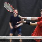 Callan Smith returns a volley as he plays doubles with partner Liam Penn, background, against Kevin Kooistra and Alain Soltys-Gray at the Region V Tennis Tournament at The Alaska Club/JRC on Wednesday. Penn and Smith won the match 6-2, 6-1, and will play Will Rehfeldt and William Smoker in the final on Saturday. (Michael Penn | Juneau Empire)