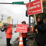 Supporters of Martin Stepetins bid for a seat on the school board and Proposition 3 wave signs in the intersection of Egan Drive and the Juneau-Douglas Bridge. Voting is from 7 a.m. to 8 p.m. on Tuesday, Oct. 1, 2019. (Michael S. Lockett | Juneau Empire)