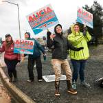 Alicia Hughes-Skandijs and some of her supporters wave signs in the intersection of Egan Drive and Douglas Bridge. Voting is from 7 a.m. to 8 p.m. on Tuesday, Oct. 1, 2019. (Michael S. Lockett | Juneau Empire)