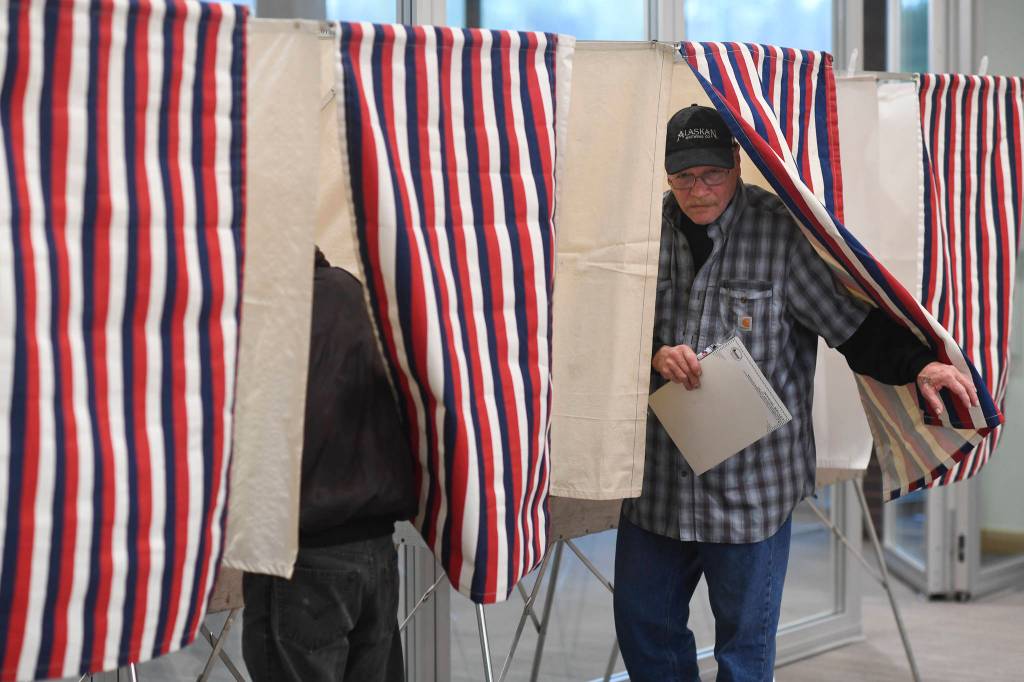 Ted Ludeman exits a booth after voting at the Mendenhall Valley Public Library on Tuesday, Oct. 1, 2019. (Michael Penn | Juneau Empire)