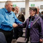 School board candidates Emil Mackey and Deedie Sorenson greet each other at City Hall on Tuesday, Oct. 1, 2019. (Michael Penn | Juneau Empire)