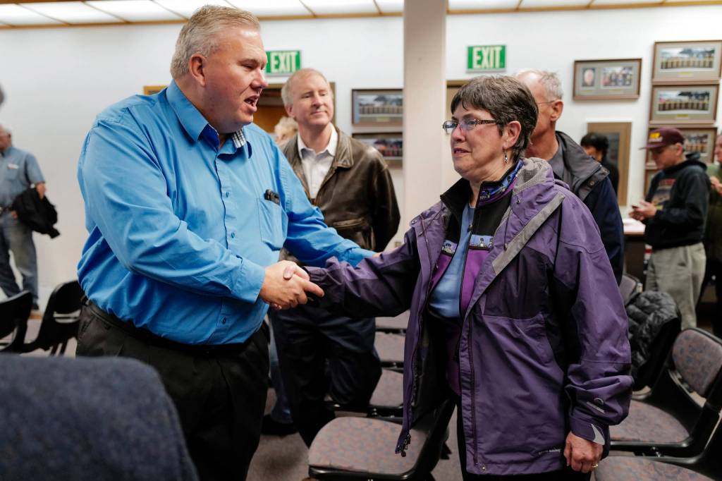 School board candidates Emil Mackey and Deedie Sorenson greet each other at City Hall on Tuesday, Oct. 1, 2019. (Michael Penn | Juneau Empire)