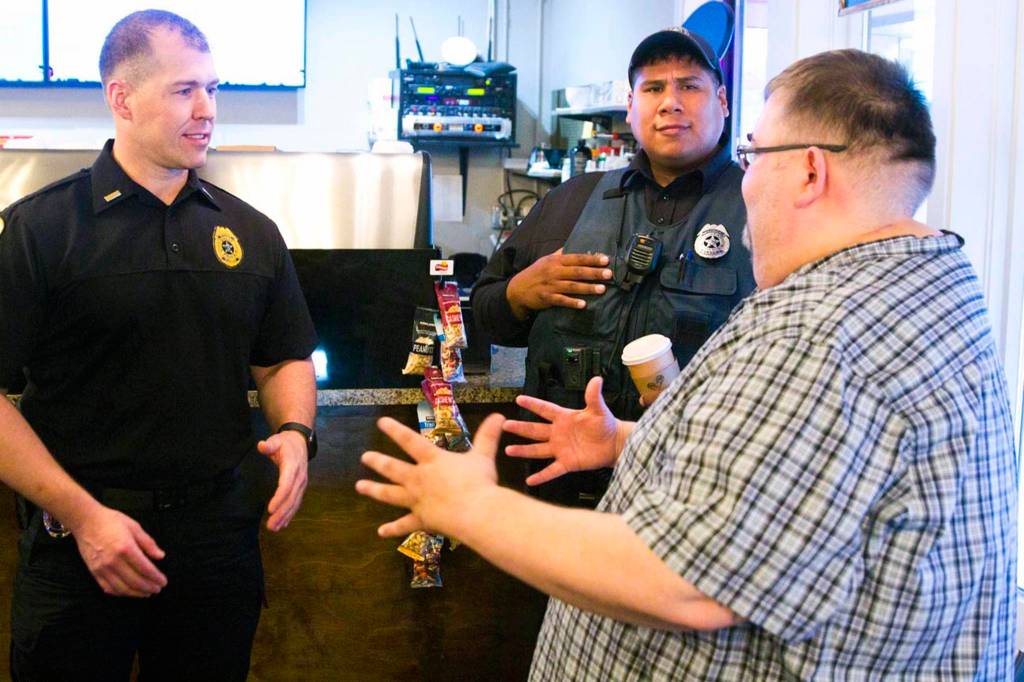 Lt. Krag Campbell with the Juneau Police Department talks with Richard Peterson, president of the Central Council of Tlingit and Haida Indian Tribes of Alaska, during Coffee with a Cop at Sacred Grounds on Oct. 2, 2019. (Michael S. Lockett | Juneau Empire)