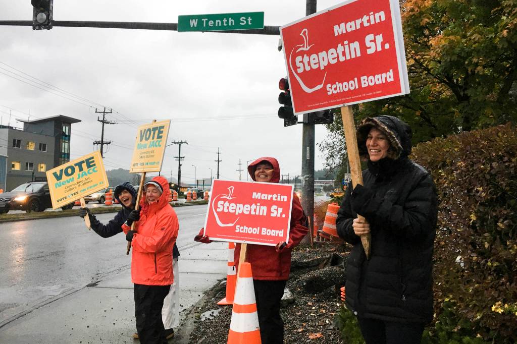 Supporters of Martin Stepetin Sr.s bid for a seat on the school board and Proposition 3 wave signs in the intersection of Egan Drive and the Juneau-Douglas Bridge. Voting is from 7 a.m. to 8 p.m. on Tuesday, Oct. 1, 2019. (Michael S. Lockett | Juneau Empire)