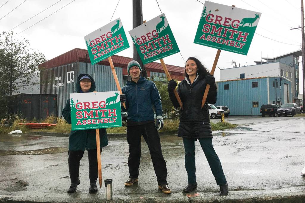 Greg Smith and some of his supporters wave signs in the intersection of Egan Drive and the Juneau-Douglas Bridge. Voting is from 7 a.m. to 8 p.m. on Tuesday, Oct. 1, 2019. (Michael S. Lockett | Juneau Empire)