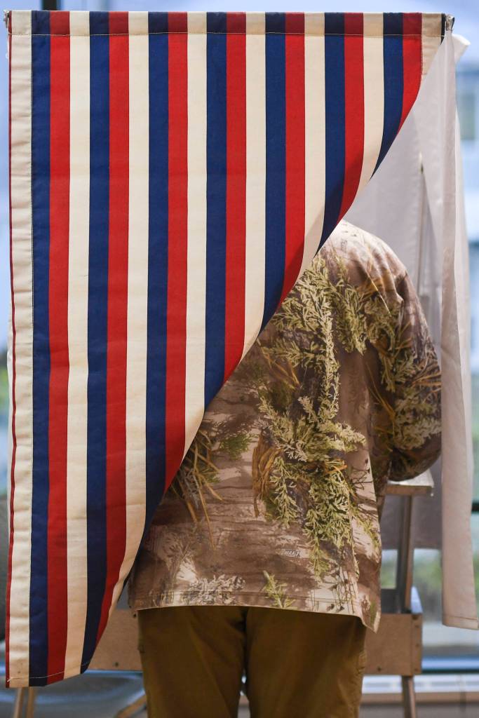 A voter shows his election day colors while voting at the Douglas Public Library on Tuesday, Oct. 1, 2019. (Michael Penn | Juneau Empire)