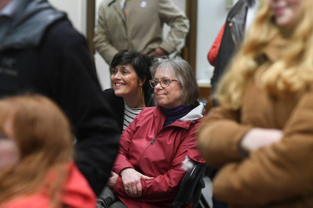 Nancy DeCherney, executive director of the Juneau Arts and Humanities Council, and Ballot Measure 3 Campaign Manager Minta Montalbo, left, watch results come in at City Hall on Tuesday, Oct. 1, 2019. (Michael Penn | Juneau Empire)