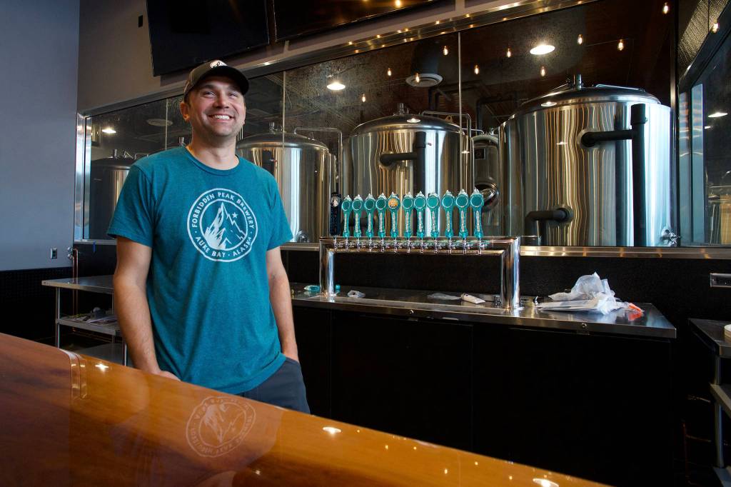 Co-owner Skye Stekoll stands behind a new bar as the Forbidden Peak Brewery nears completion on Thursday, Oct. 3, 2019. The Auke Bay brewery is to open Saturday, Oct. 12. (Michael Penn | Juneau Empire)