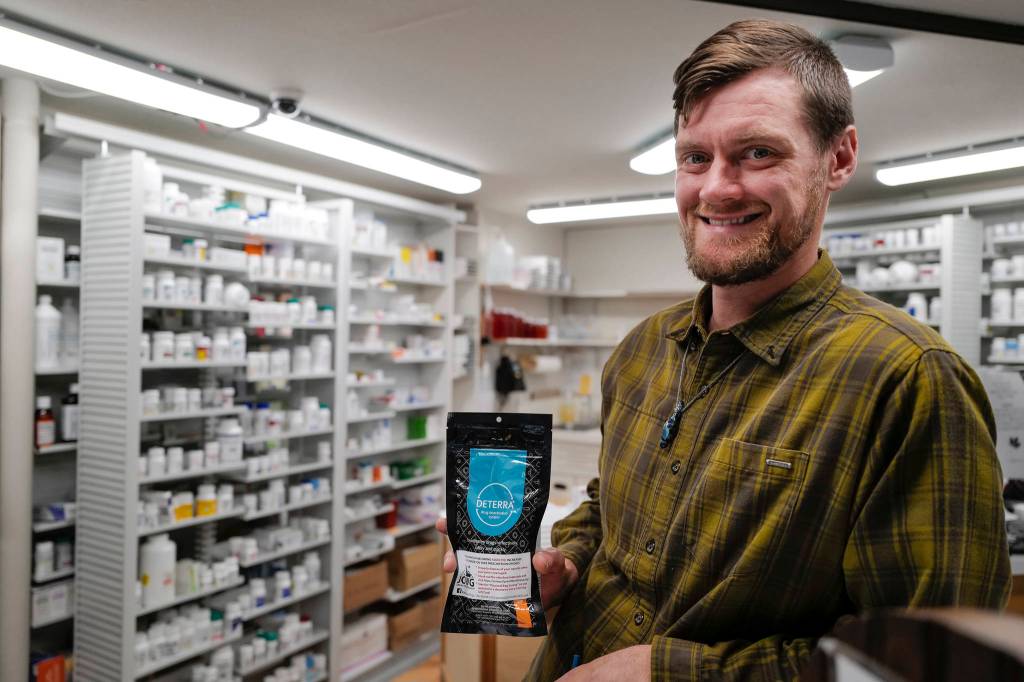 Adam Nelson, a pharmacist at Juneau Drug, displays a drug deactivation bag on Tuesday, Oct. 1, 2019, he gives out with opioid prescriptions. People can use the bag to safely dispose of unused drugs. (Michael Penn | Juneau Empire)